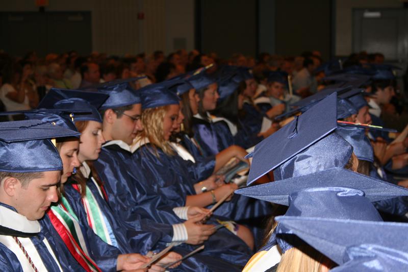Dozens of students dressed in graduation attire attend the UD Department of Communication convocation ceremony.