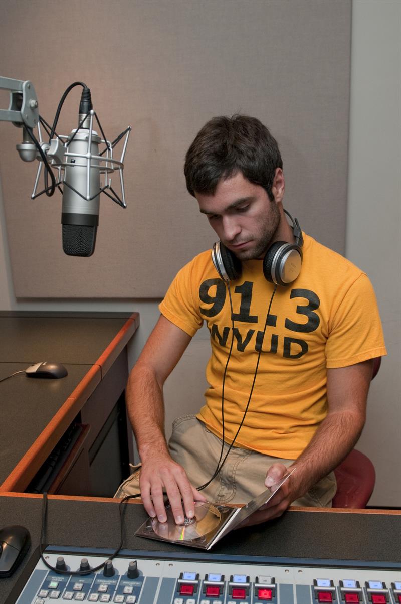 Student prepares music for a broadcast inside WVUD studios